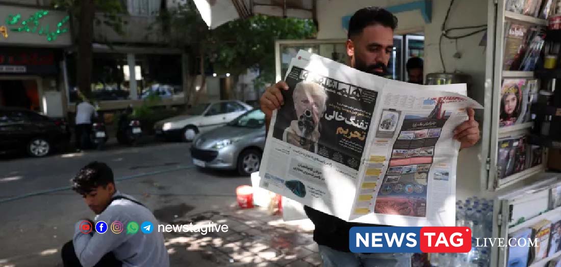 An Iranian man reads a copy of the newspaper Hamshahri