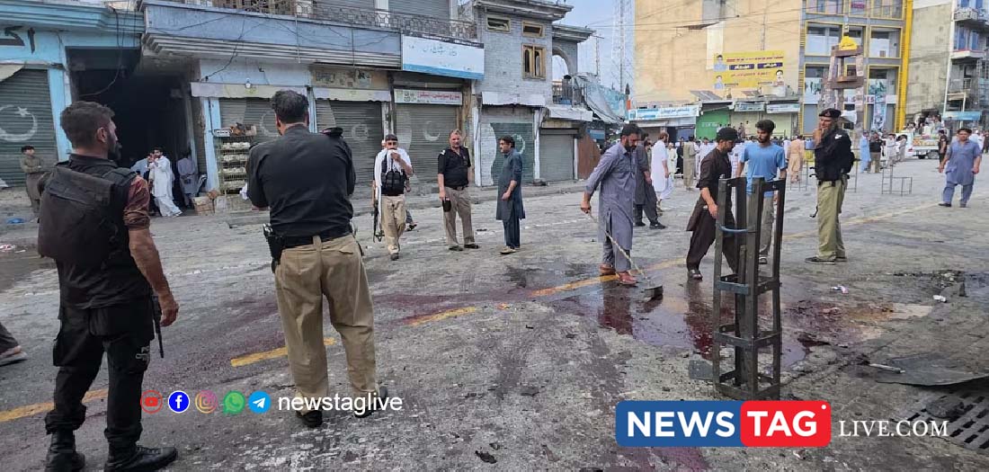 Police officers examine the site following a suicide bombing, in Kabal